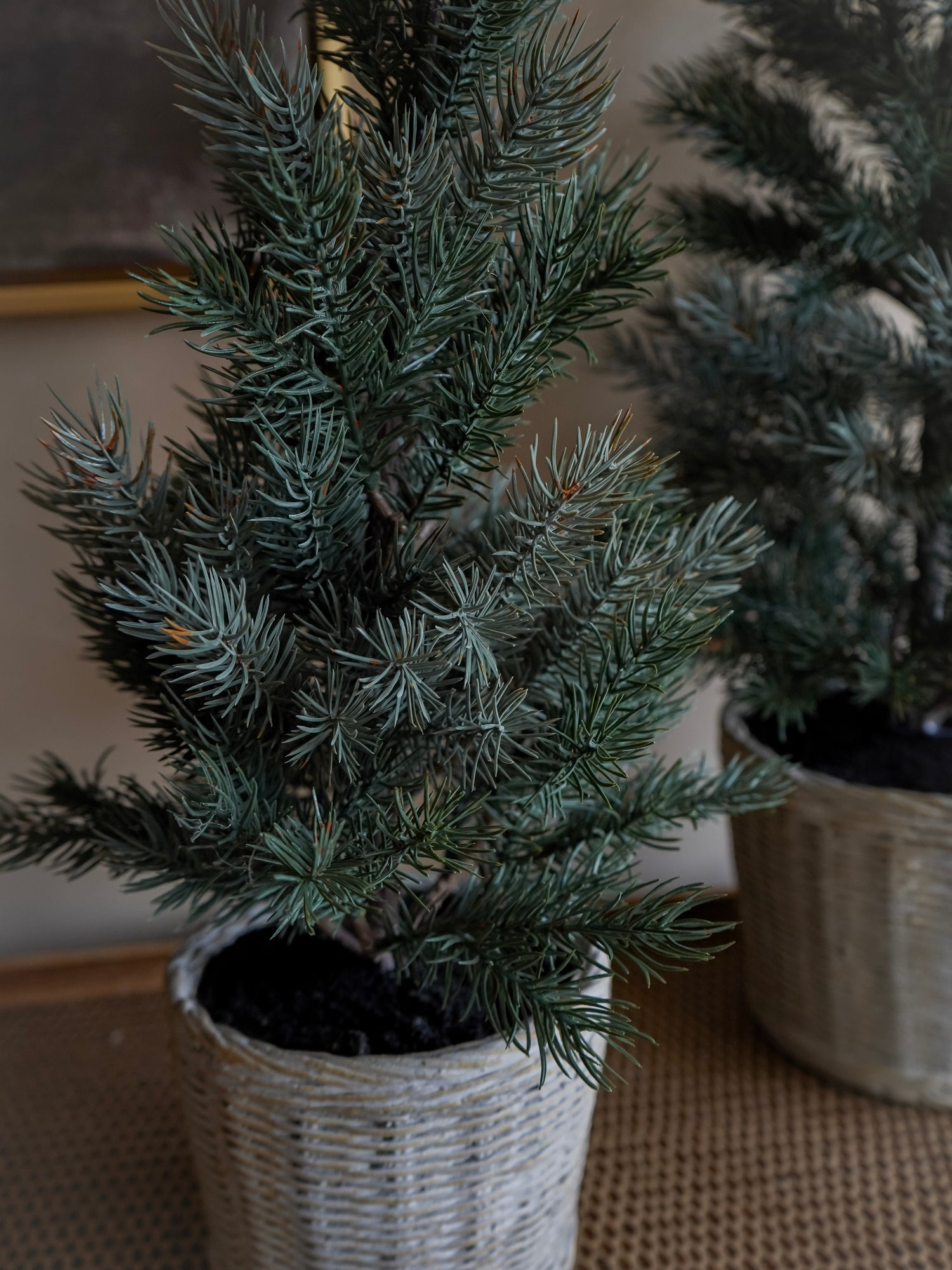 Potted artificial Christmas tree on a neutral background