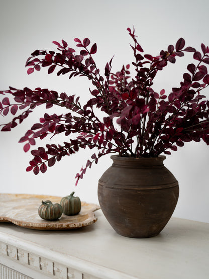 faux plum leaves in rustic brown vase, autumn inspired home styling