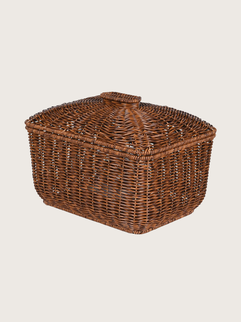 Wicker basket with a lid on a light beige background