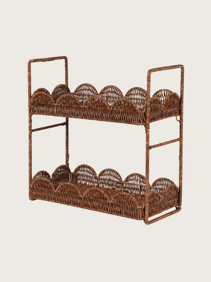 Wicker shelf with scalloped edges on a plain background
