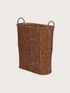 Wicker umbrella basket on a light beige background