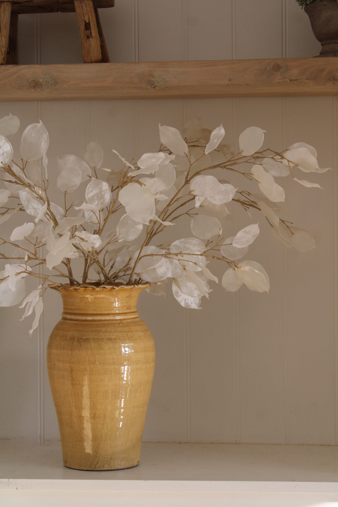 Faux Silver Dollar Honesty Spray styled en masse in ochre terracotta tall vase