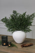 Faux Woodland Cedar Spray in white ceramic vase
