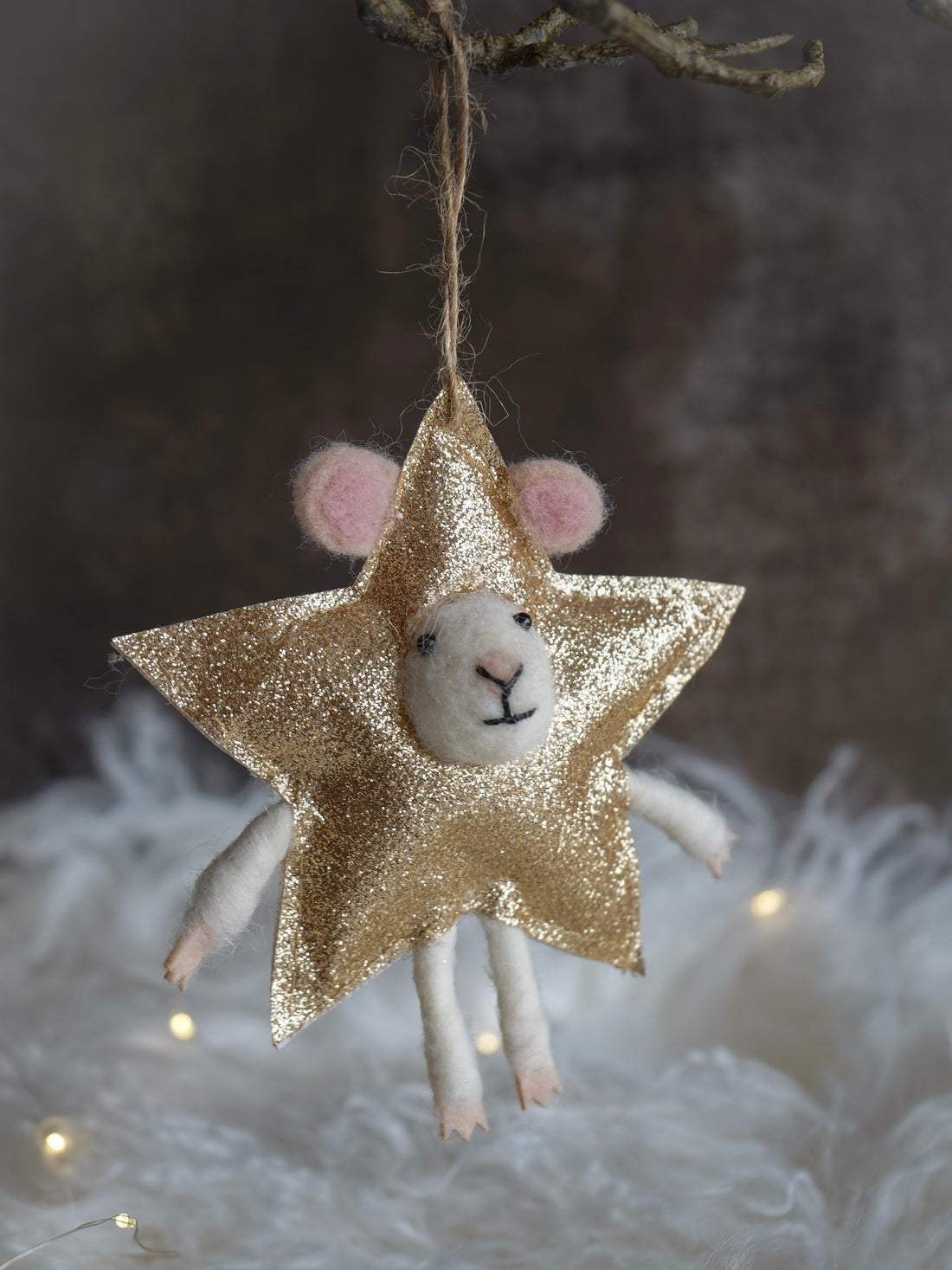 Decorative star-shaped ornament with a small animal face on a textured background