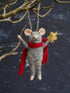 Decorative mouse ornament with a red cape and gold star against a dark background