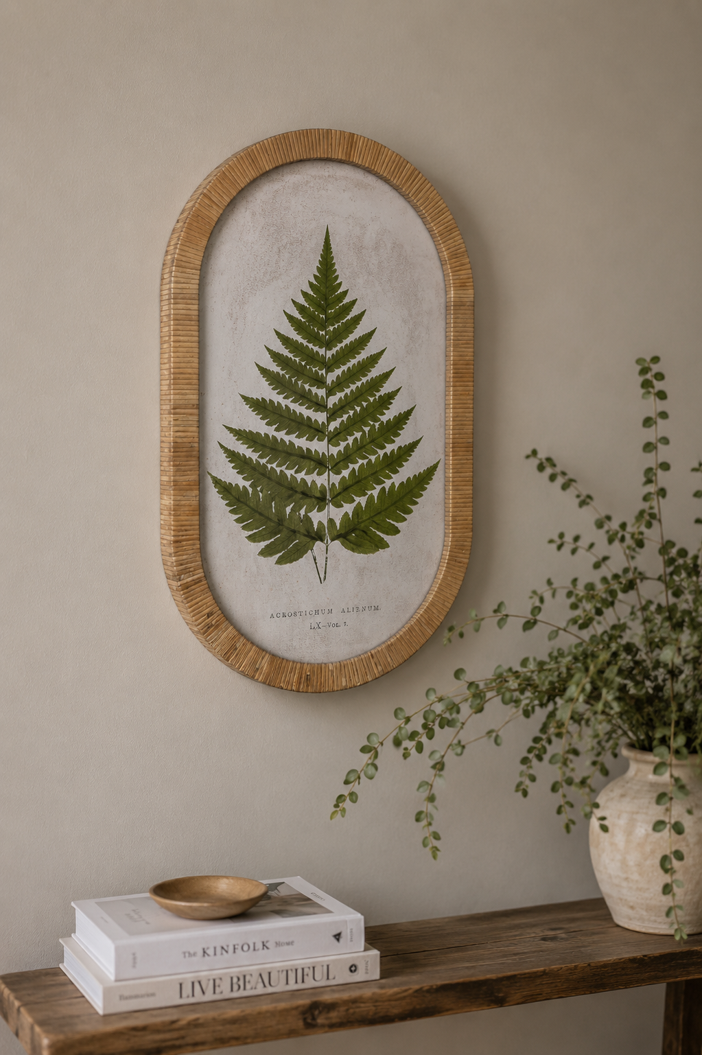 minimalist hallway setting with fern leaf print in rounded rattan frame