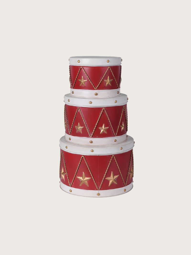 Set of three red and white decorative boxes with gold star and triangle patterns on a light gray background.