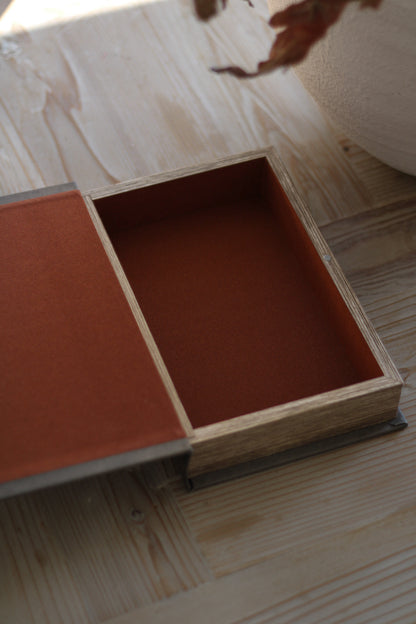 Wooden box with a red interior on a wooden surface