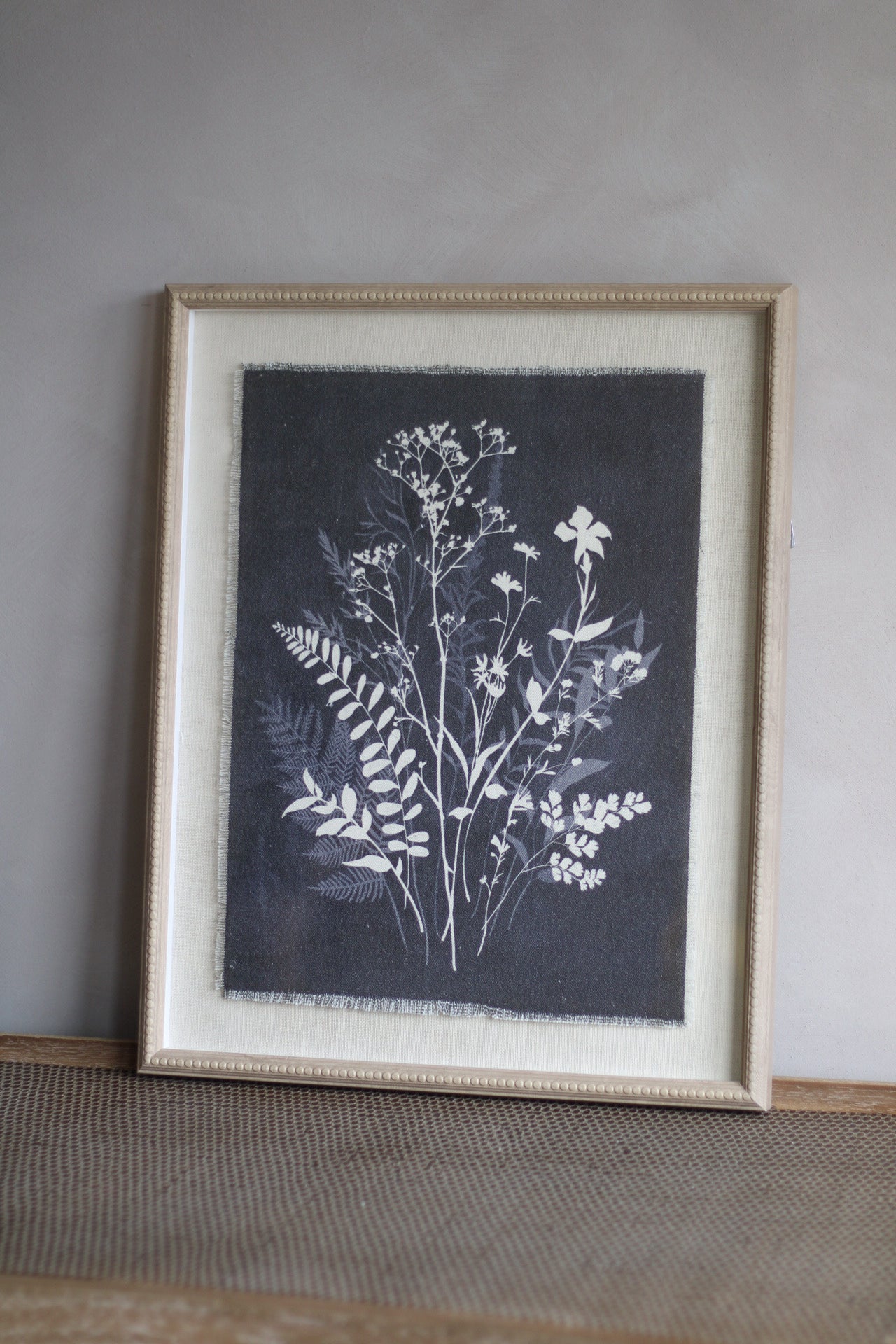 Framed botanical print on a gray wall