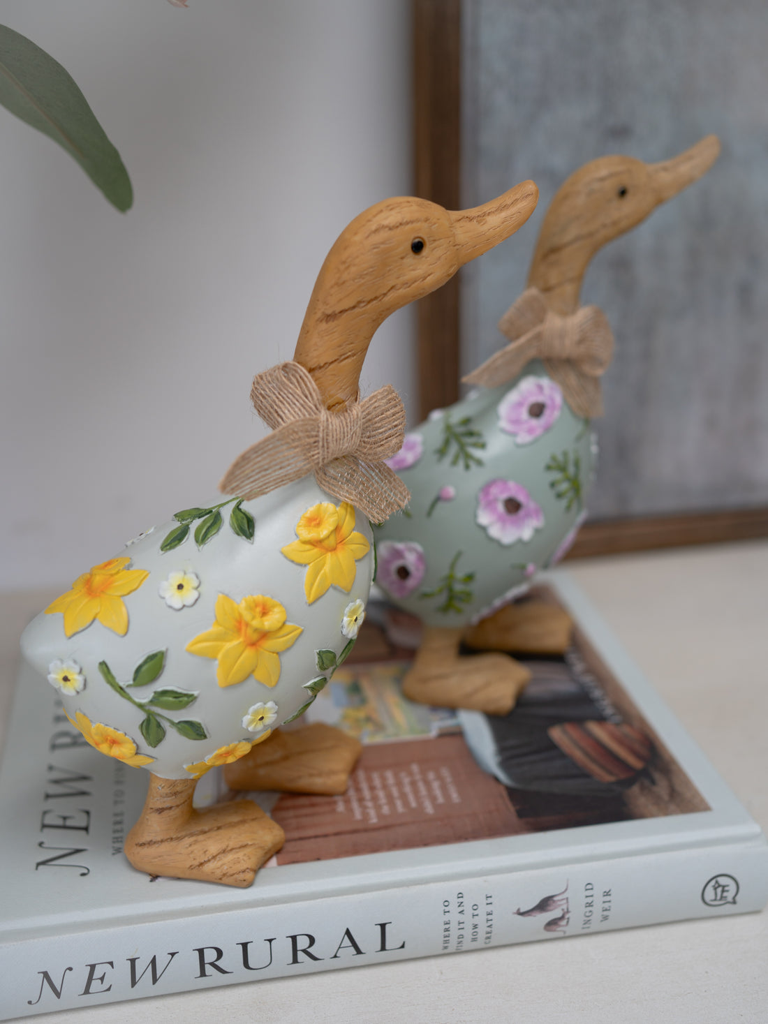 Decorative duck figurines with floral patterns on a book
