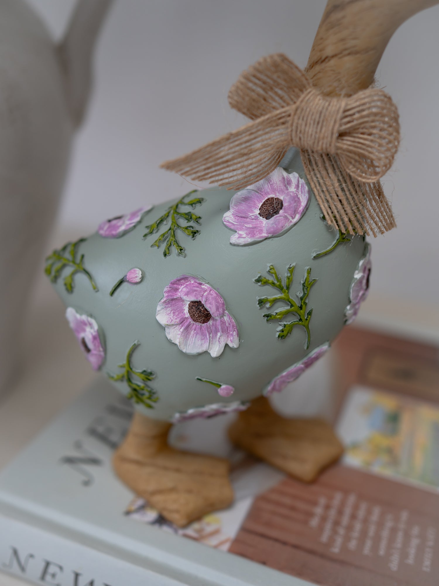 Decorative Easter egg with floral patterns and a bow on a magazine