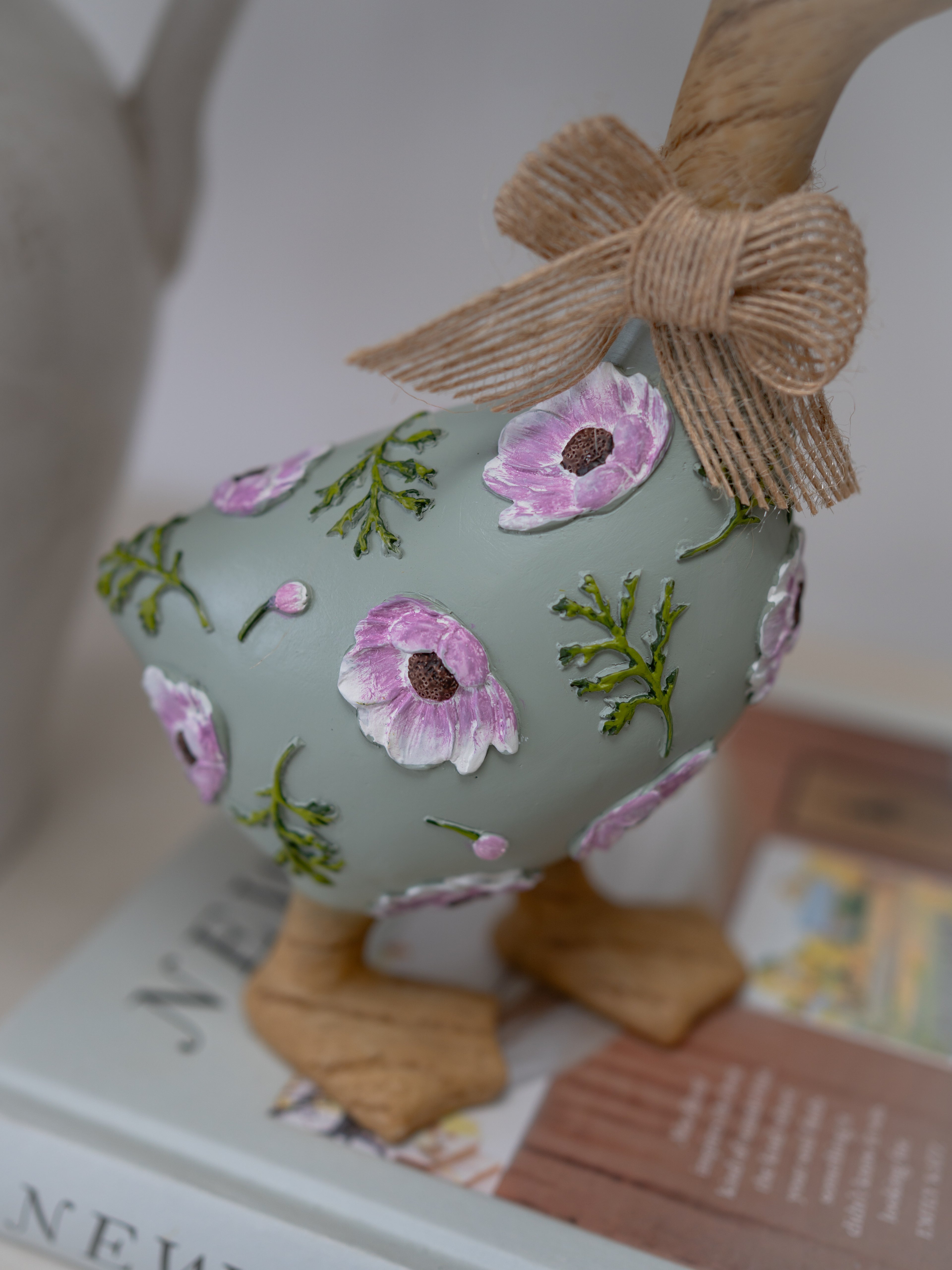 Decorative Easter egg with floral patterns and a bow on a magazine