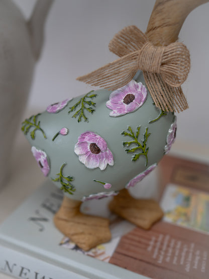 Decorative Easter egg with floral patterns and a bow on a magazine
