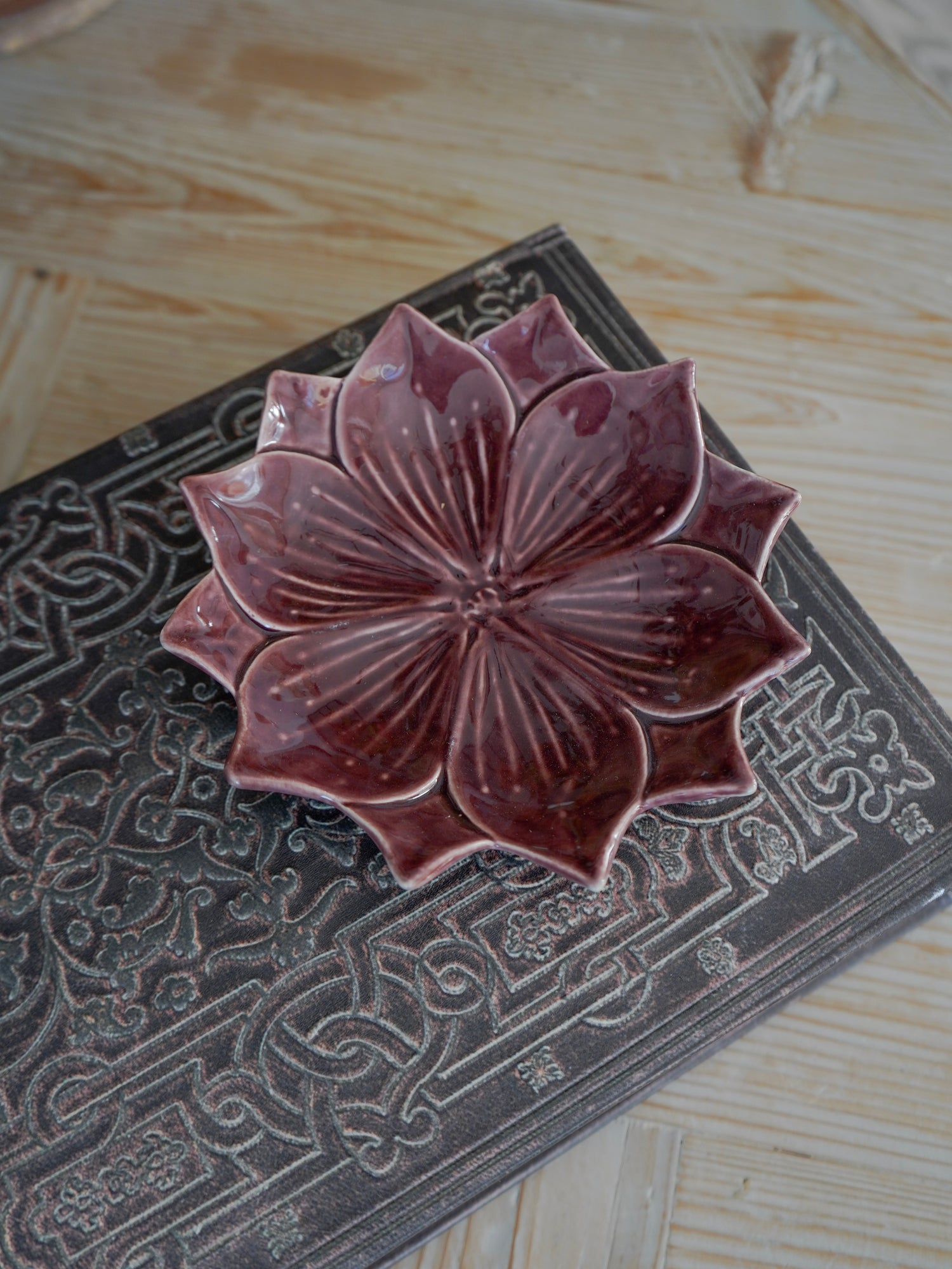 Ceramic lotus flower on a textured surface