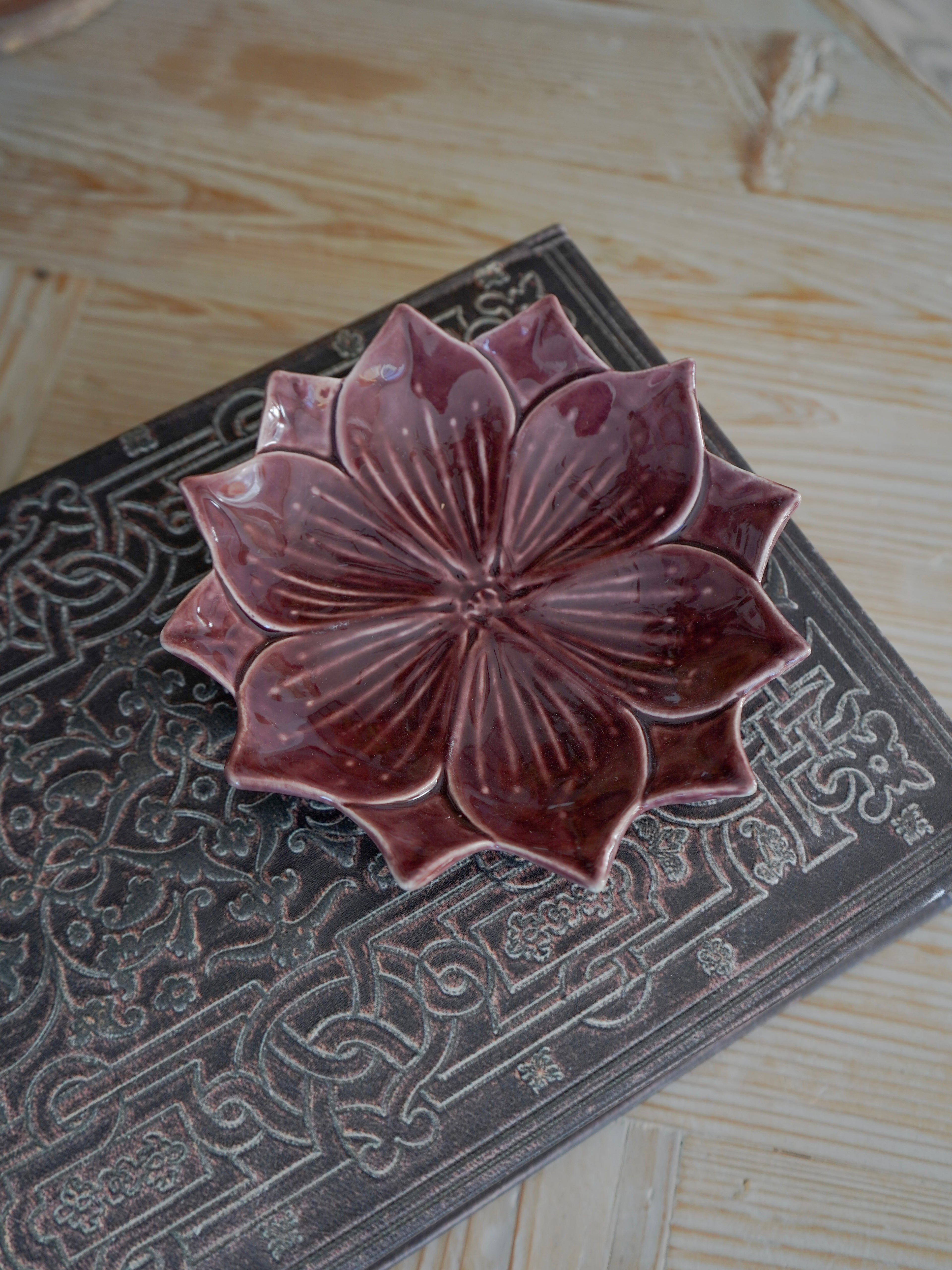Ceramic lotus flower on a textured surface