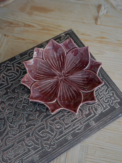 Ceramic lotus flower on a textured surface