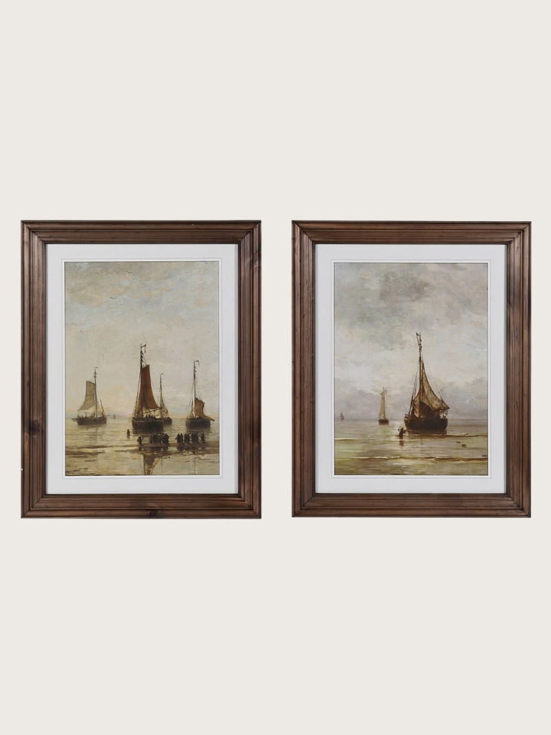 Two framed paintings of boats on a beige background