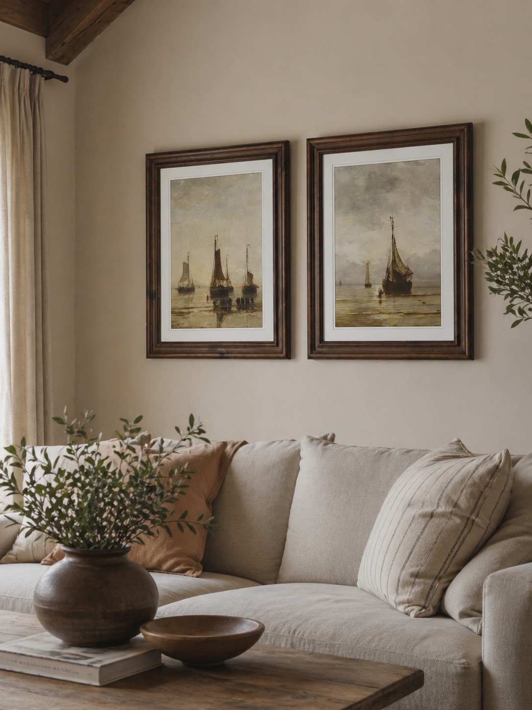 Living room with beige sofa, framed vintage style ships artwork, and decorative items.