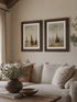 Living room with beige sofa, framed vintage style ships artwork, and decorative items.