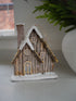 Frosted Lodge Cabin with white textured vase and faux norfolk pine branch in the background