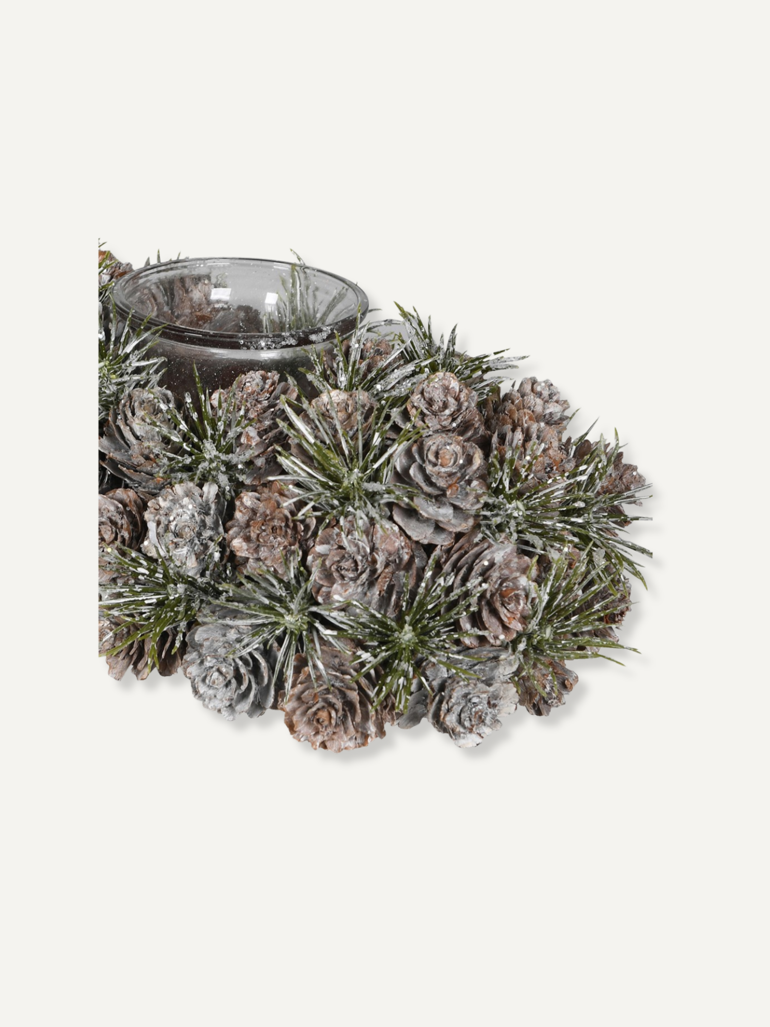 A winter-themed pinecone and frosted greenery centerpiece with a small clear glass bowl, photographed on a plain light gray background.