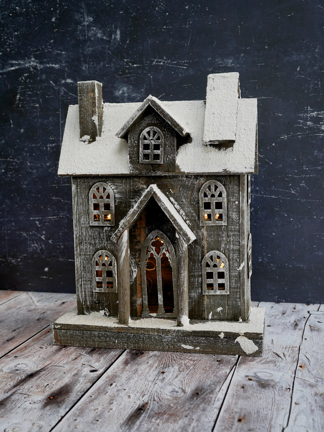 Wooden model of a house with a dark background