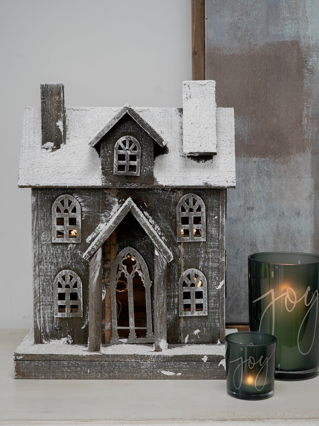 Decorative house with a candle labeled &