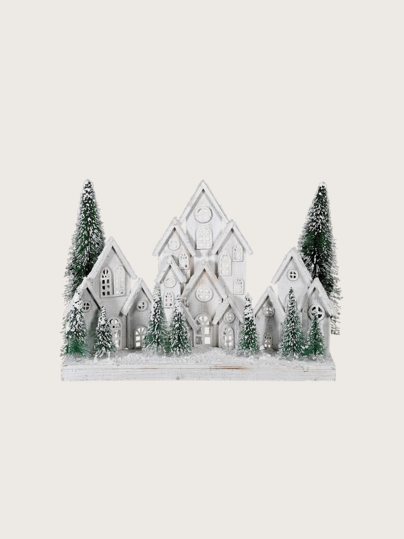 Decorative model of a snowy village with trees on a white background