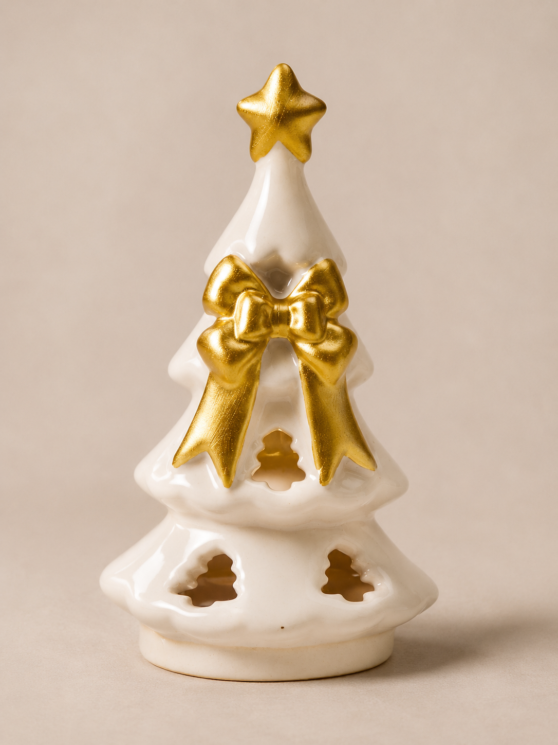white ceramic christmas tree with golden bow