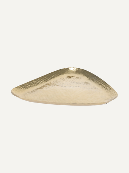 A triangular gold-toned tray with a hammered texture, photographed on a solid off-white background.