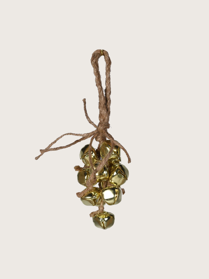 Decorative hanging gold bells on a beige background