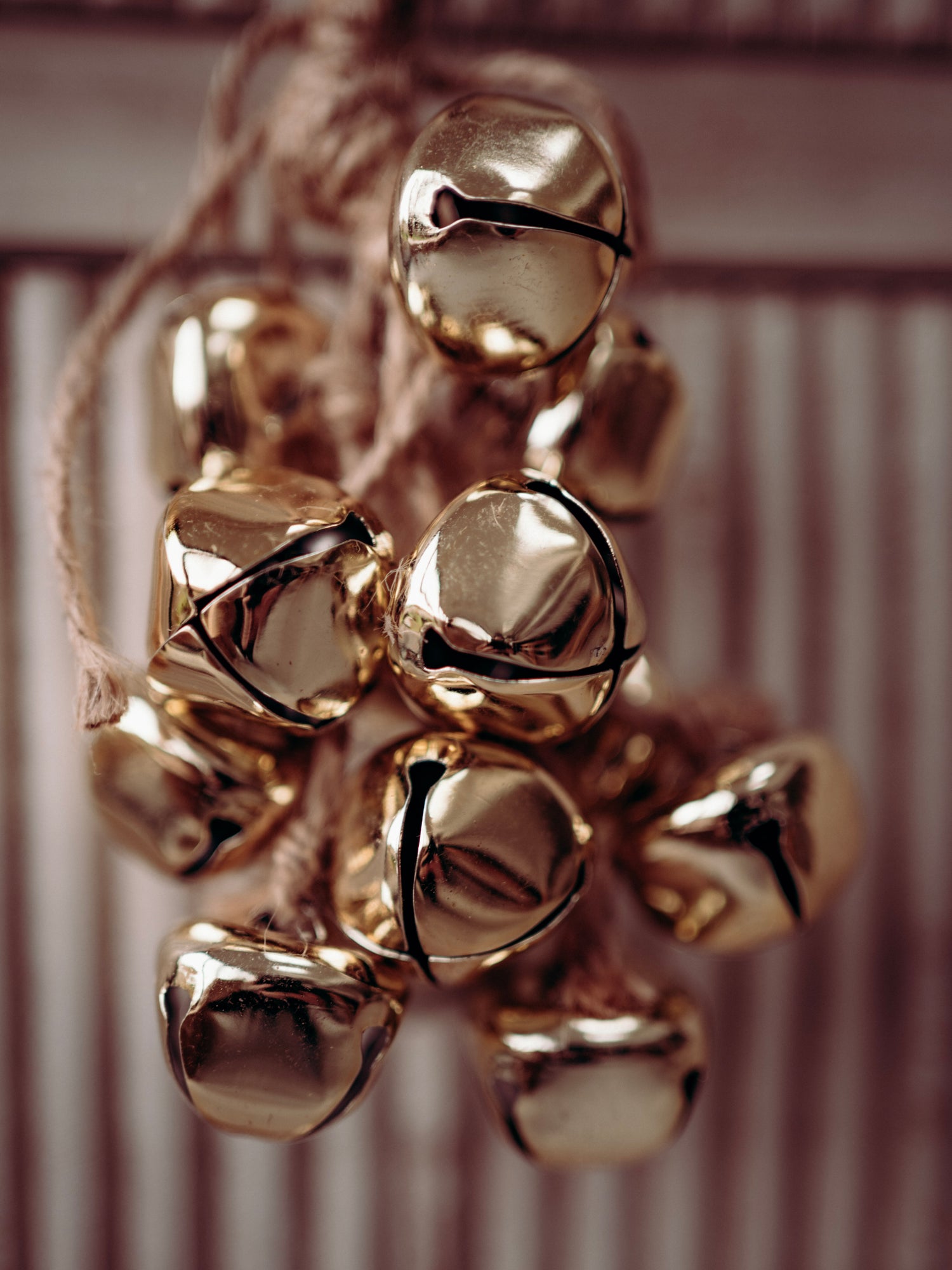 Close-up of gold jingle bells on a blurred background