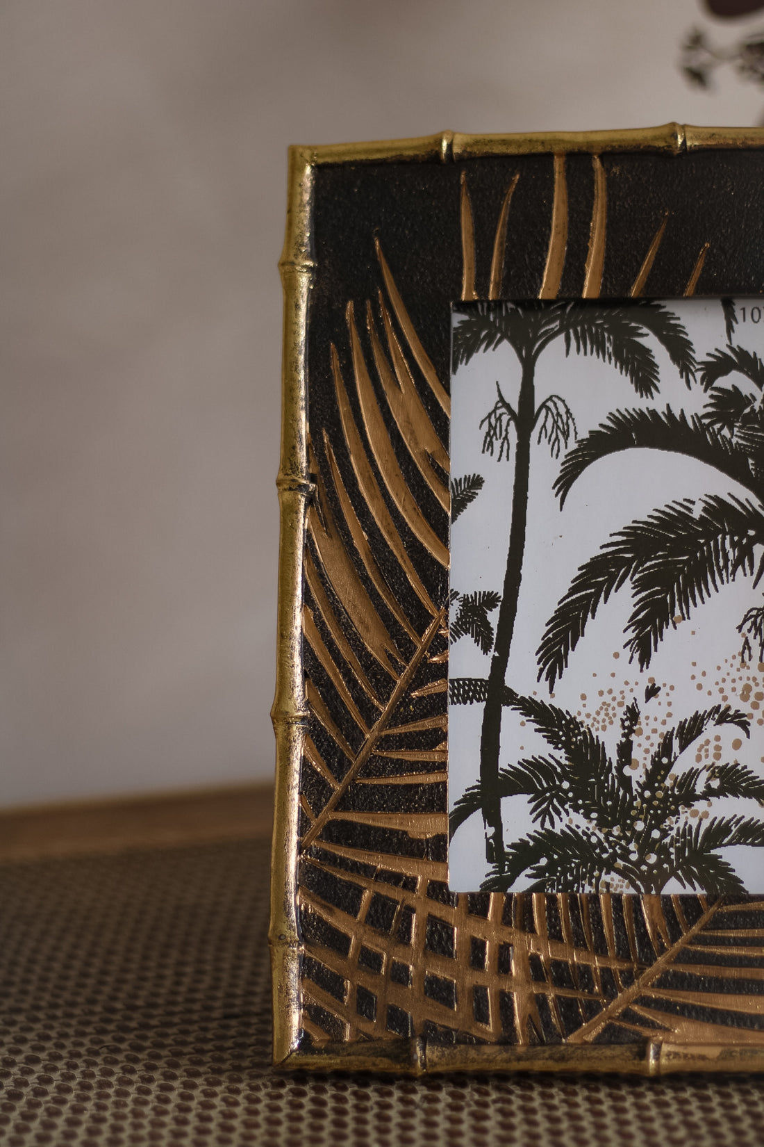 Up close of golden palm leaf photo frame