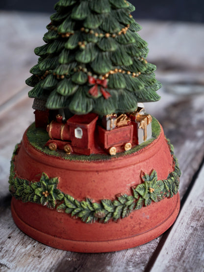 Decorative Christmas tree with train and presents on a wooden base