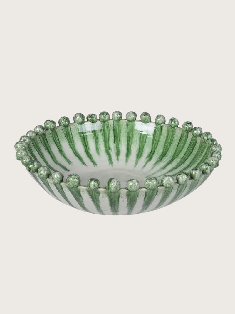 Decorative green dripping effect bowl with green stripes and bead-like accents on a light gray background