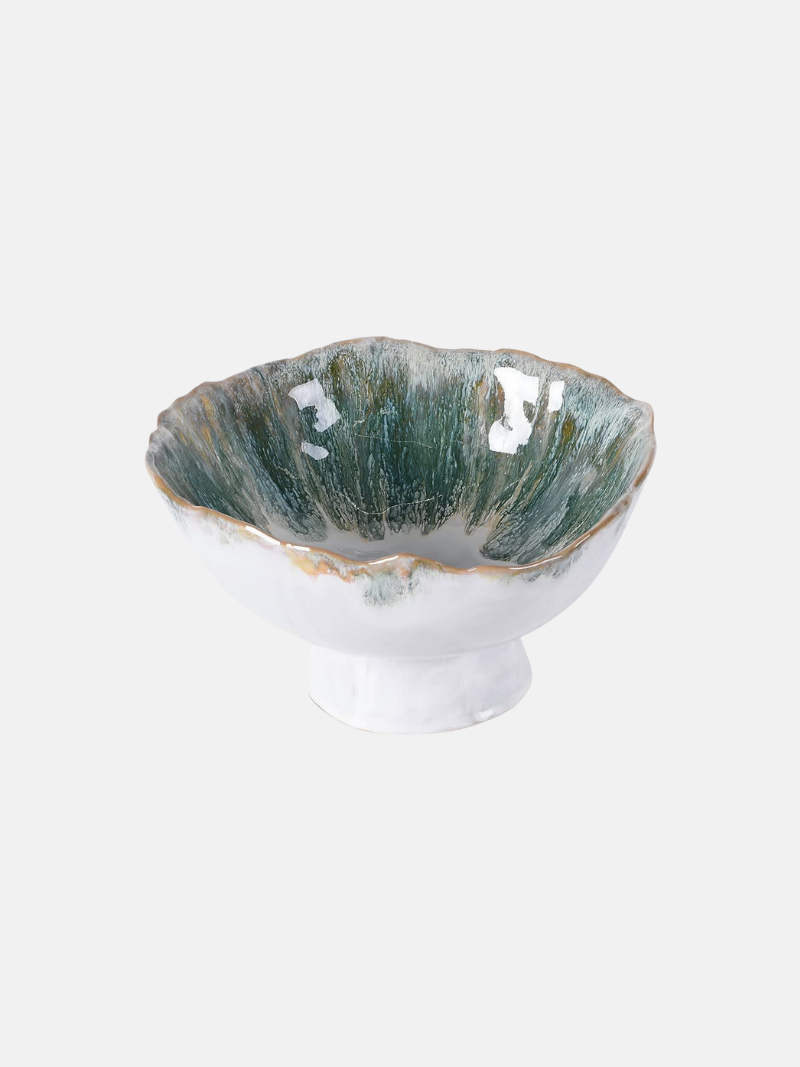 Ceramic bowl with greenish-blue interior and white exterior on a light gray background