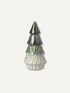 A large ceramic Christmas tree ornament with a glossy dark green and blue glazed top and a textured off-white fluted base, centered on a light beige background.