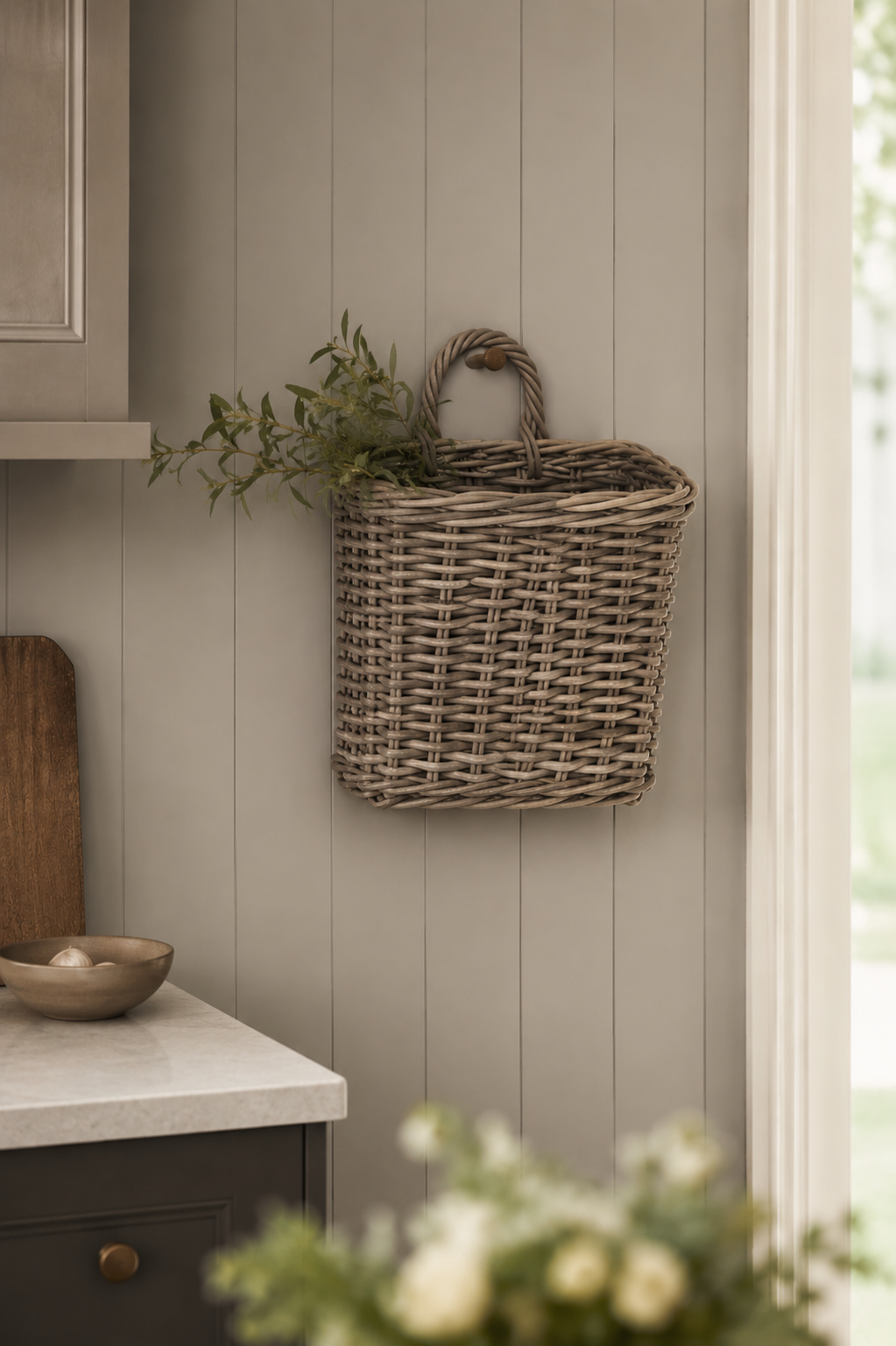 Woven wicker basket hanging on a wall with a neutral color scheme