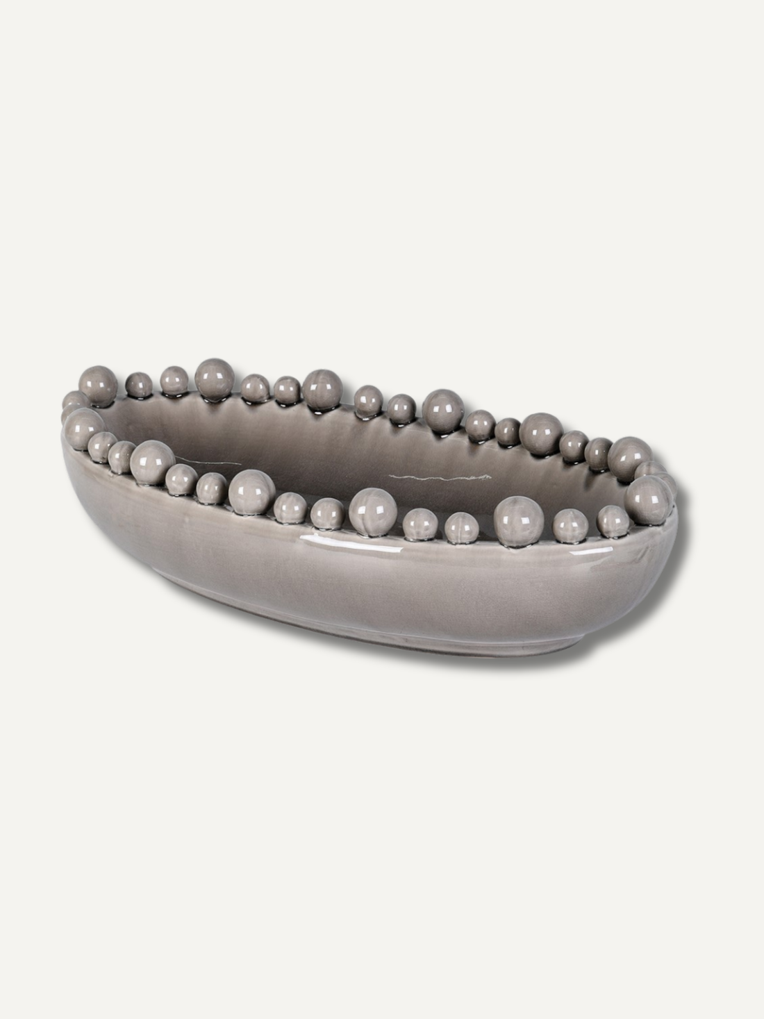 Grey decorative bowl with bobble embellishments on a white background