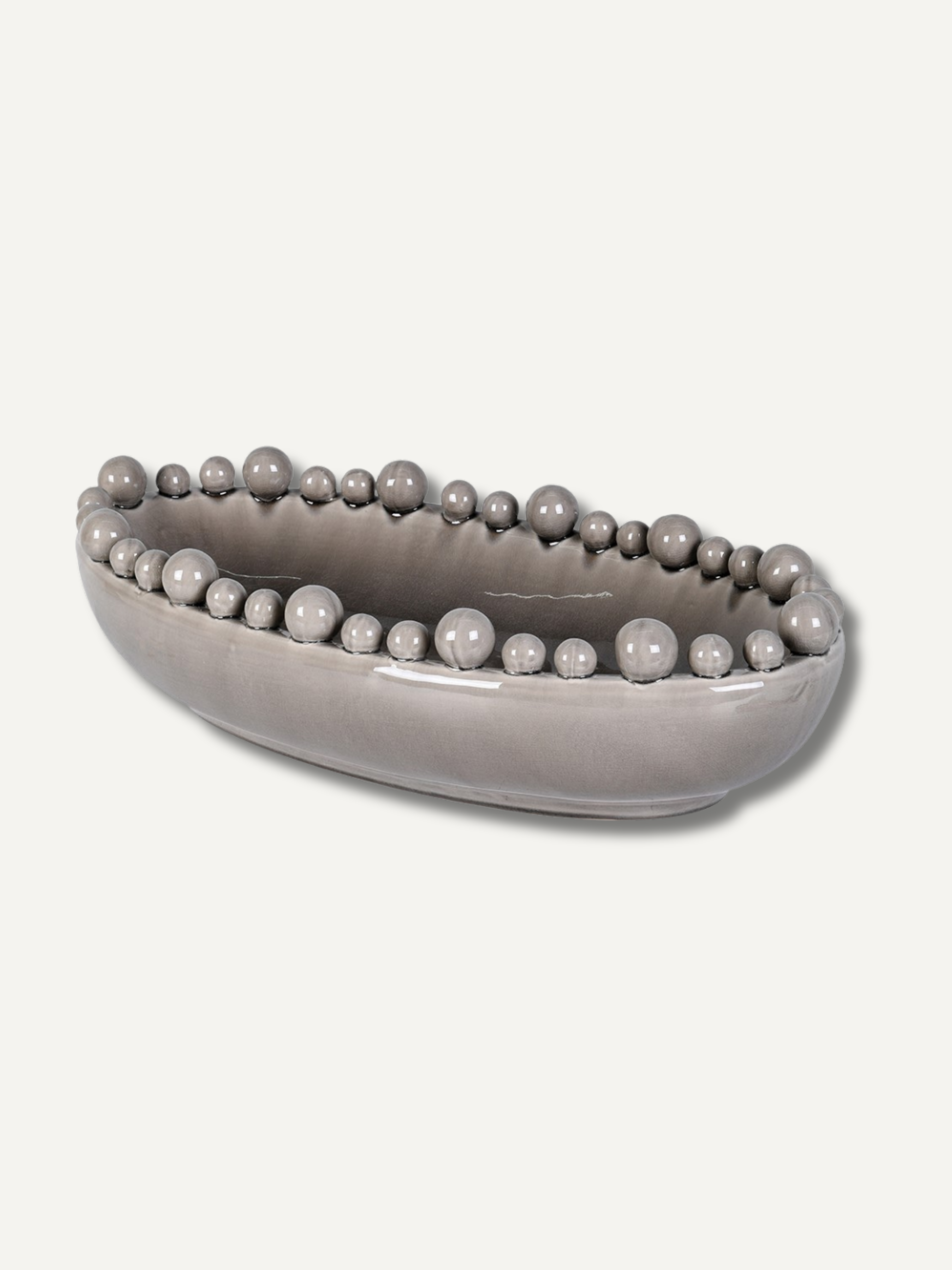 Grey decorative bowl with bobble embellishments on a white background