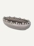Grey decorative bowl with bobble embellishments on a white background