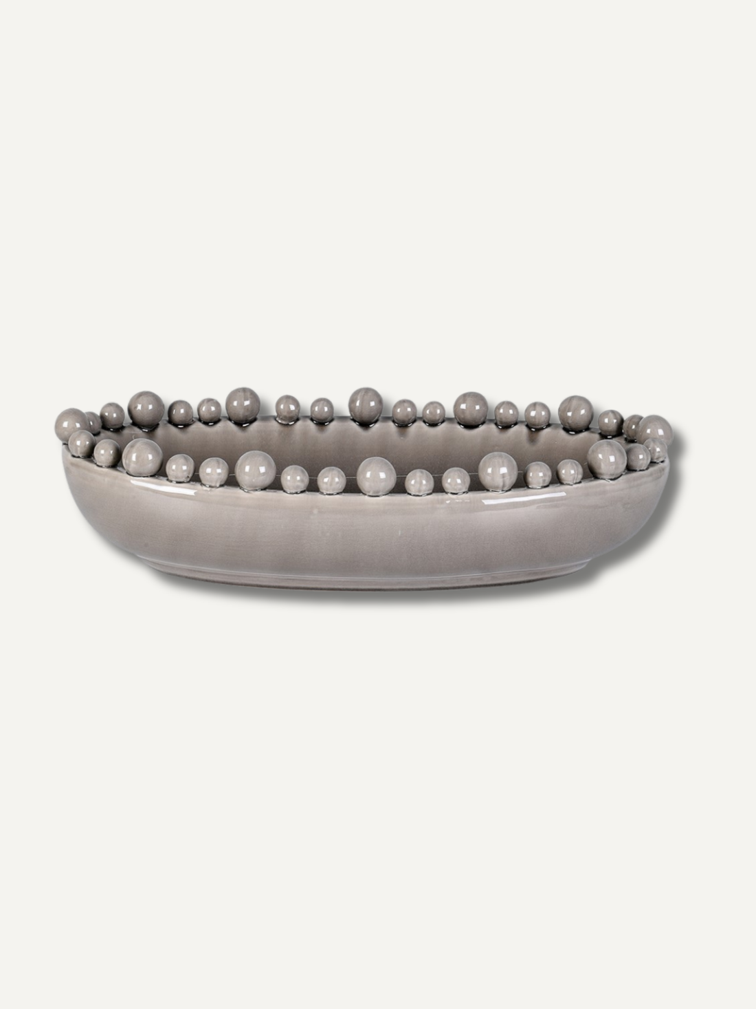 Grey decorative bowl with bobble embellishments on a white background