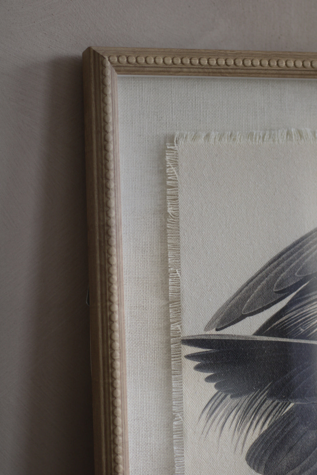 Framed artwork with a leaf design on a neutral background