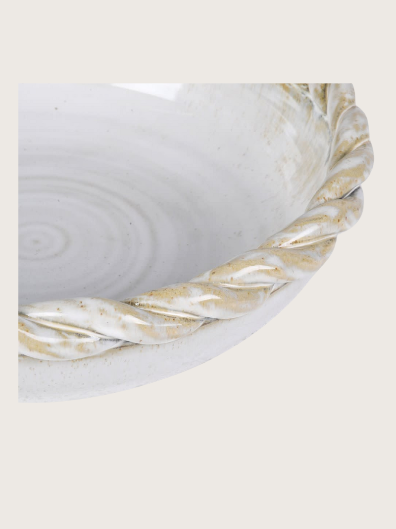 White ceramic bowl with gold decorative rim on a white background