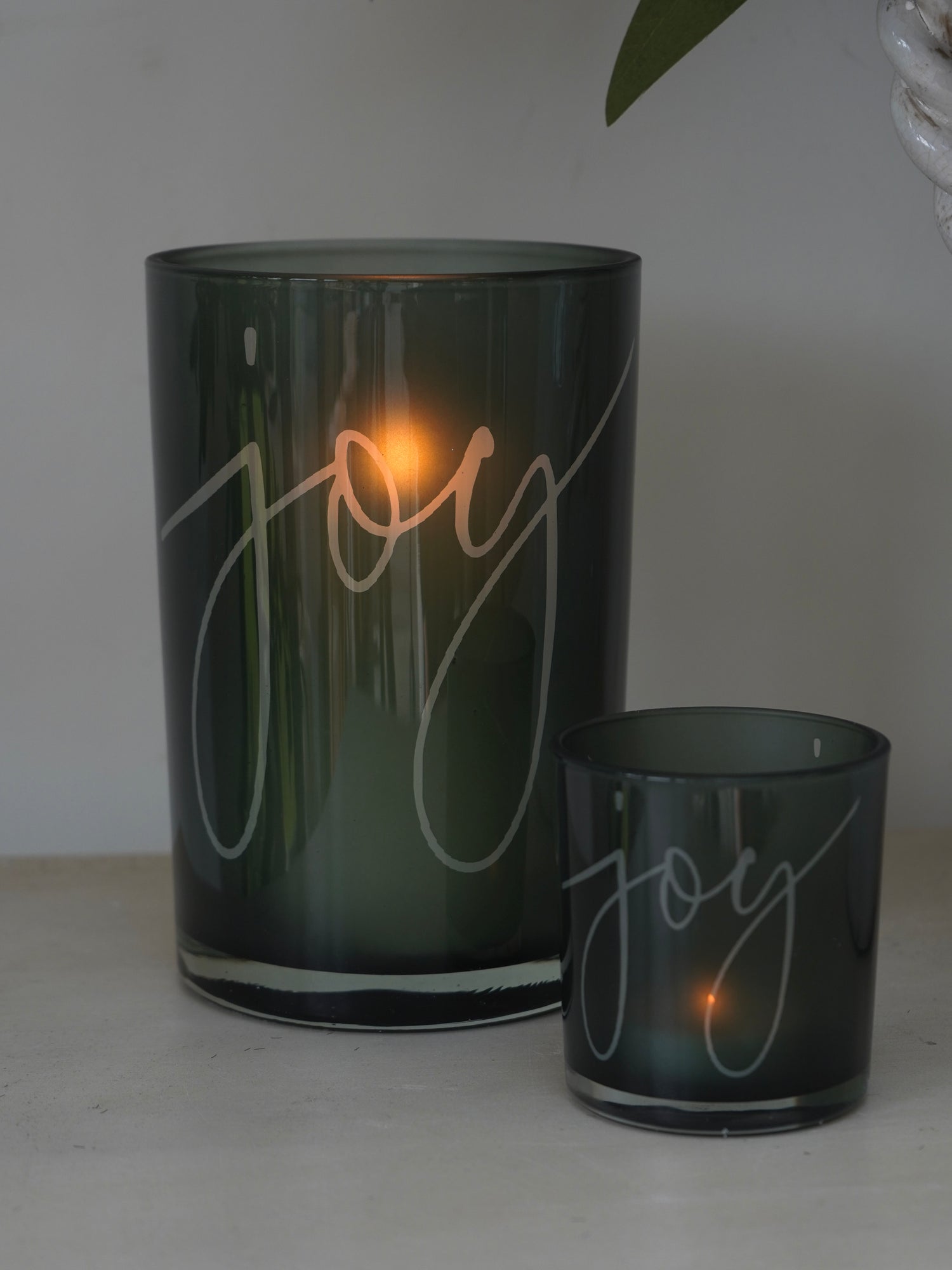Two green candle holders with &