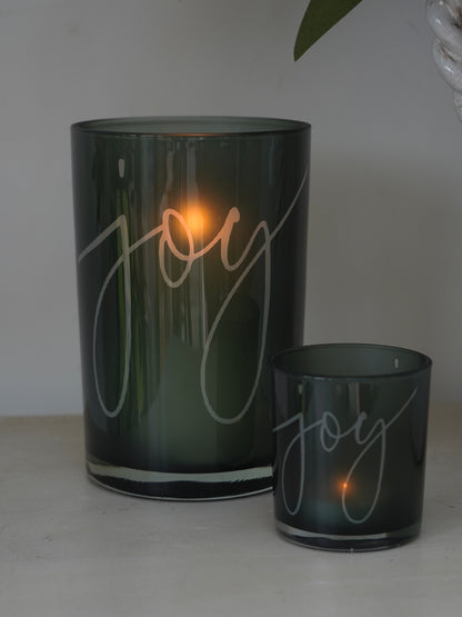Two green candle holders with &