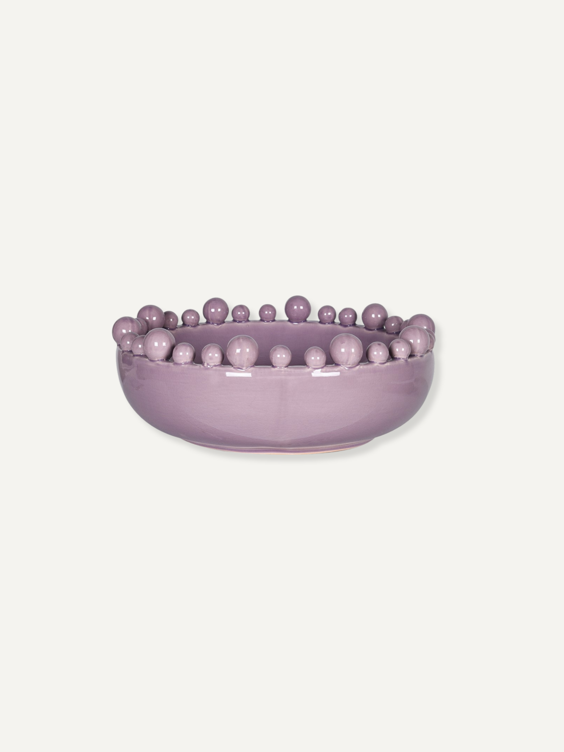 A lavender purple ceramic bowl featuring a raised border of small, evenly spaced decorative beads, shown against a solid off-white background.
