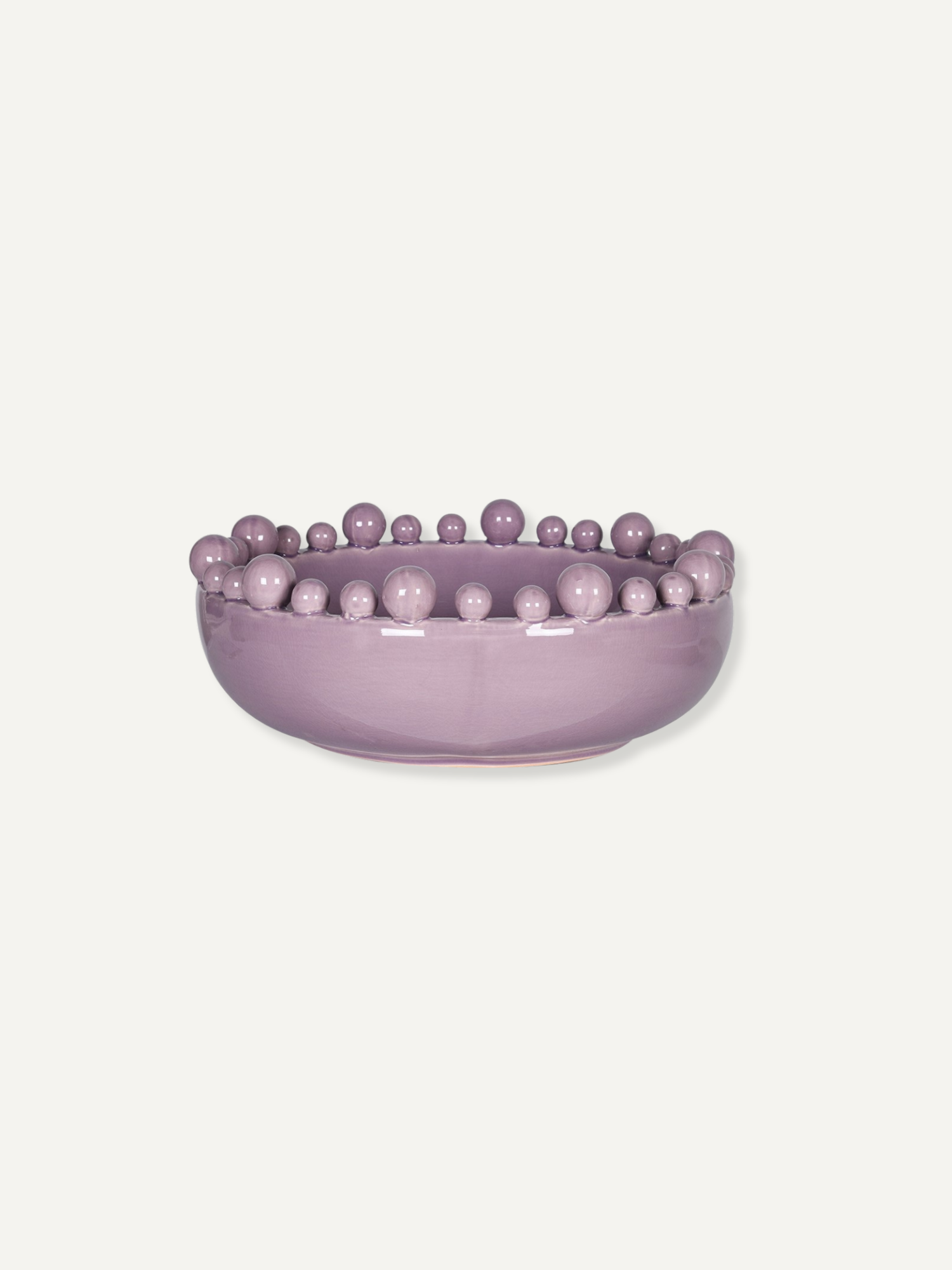 A lavender purple ceramic bowl featuring a raised border of small, evenly spaced decorative beads, shown against a solid off-white background.