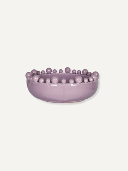 A lavender purple ceramic bowl featuring a raised border of small, evenly spaced decorative beads, shown against a solid off-white background.