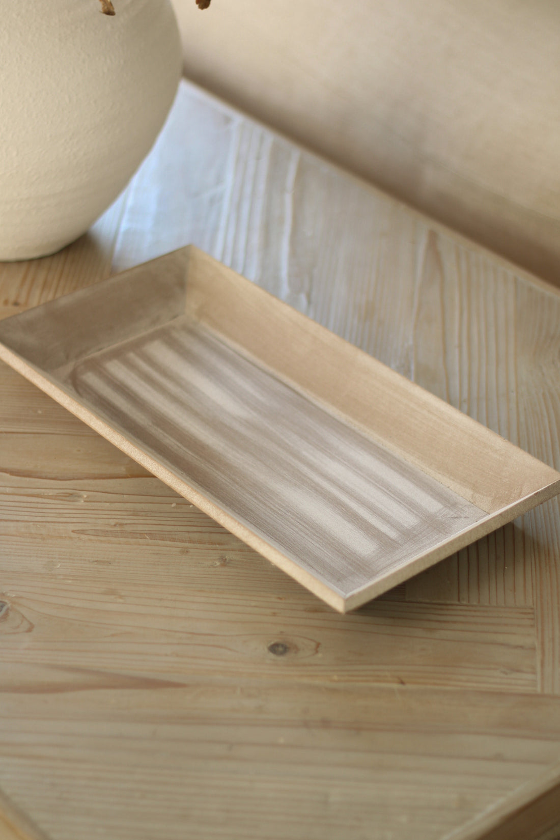 Rectangular wooden tray on a wooden surface